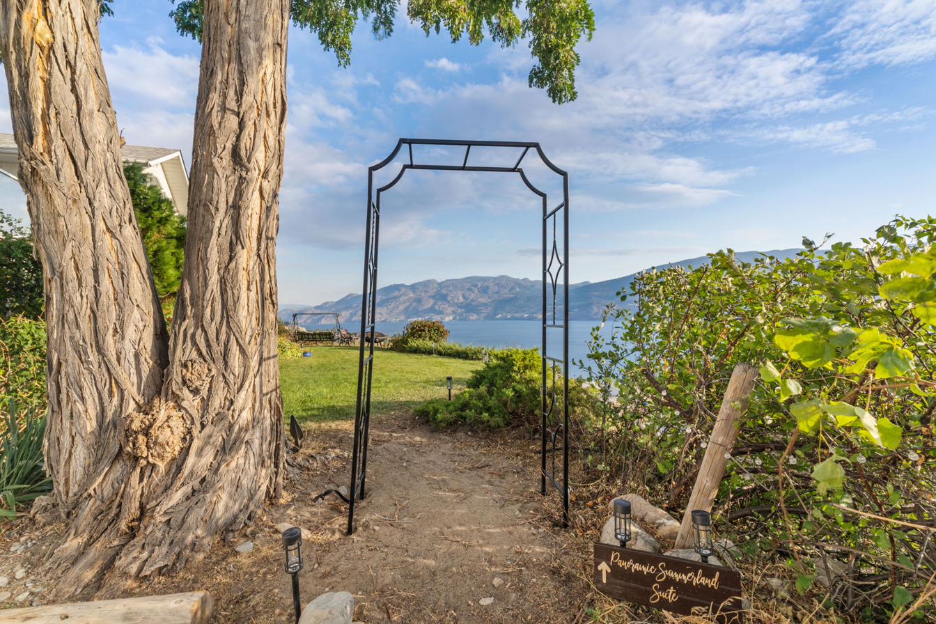 Stone archway entrance to the property — look for the twin wine barrels