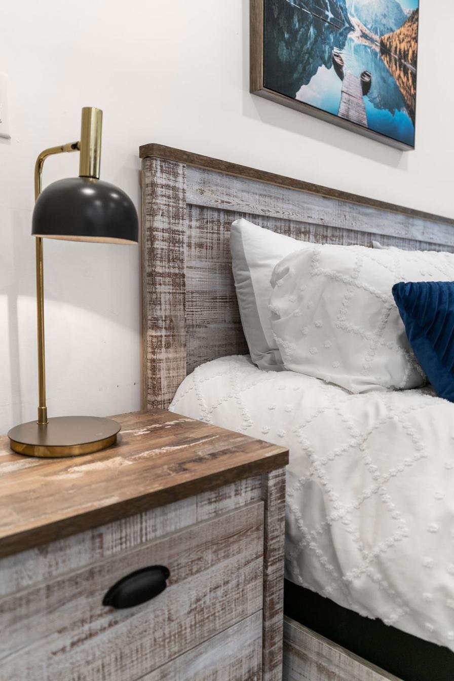 Bedside table with reading lamp and thoughtful touches
