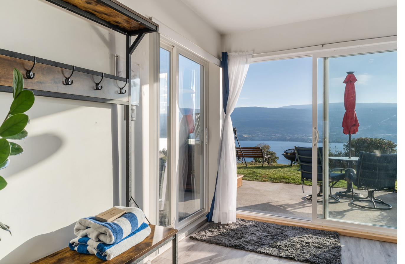 Entry hall with sliding doors opening to patio and lake view